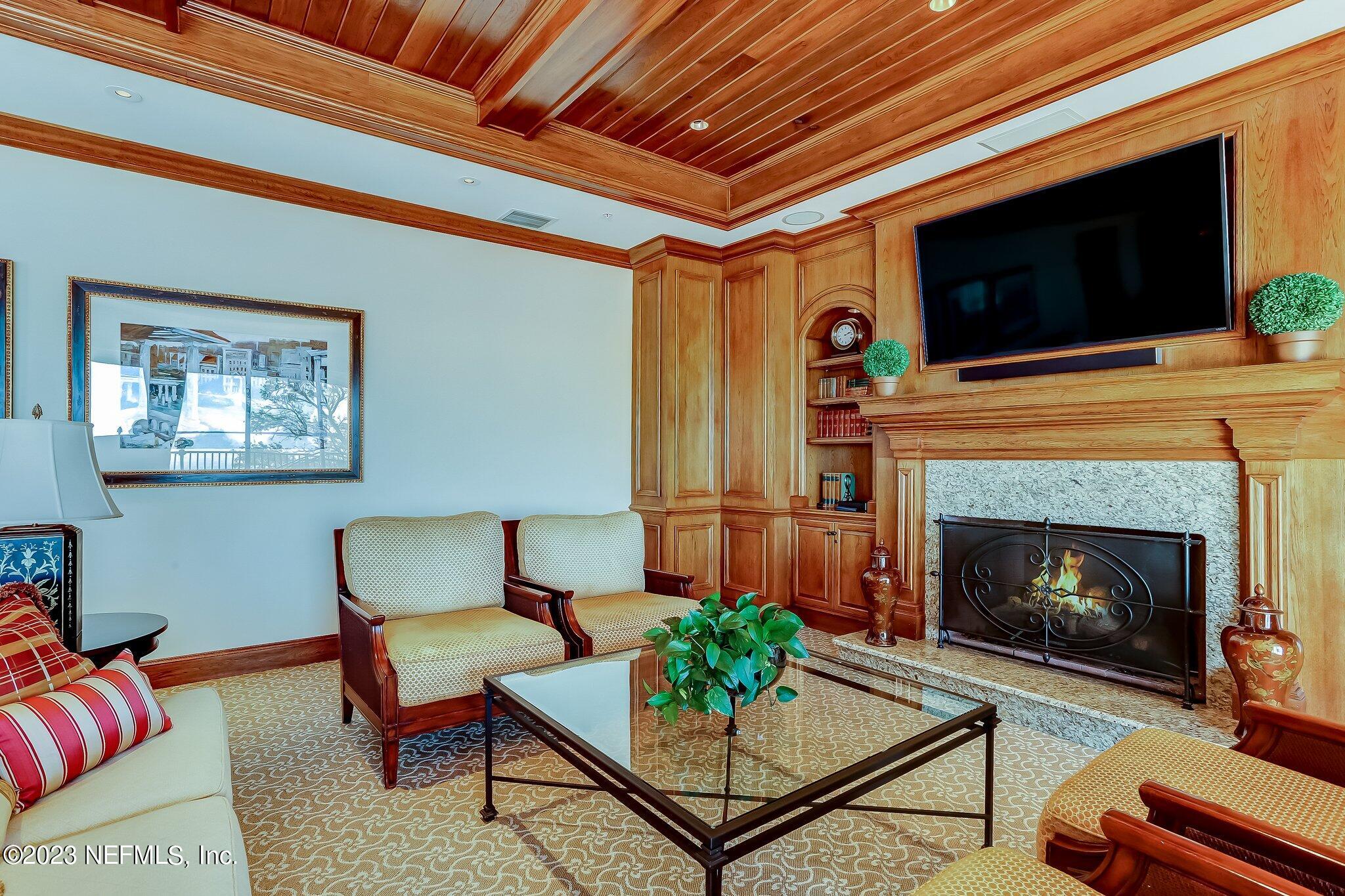 2358 Riverside Avenue, Unit 401 Jacksonville, FL 32204 - Photo 78 of 92 a living room with furniture a flat screen tv and a fireplace