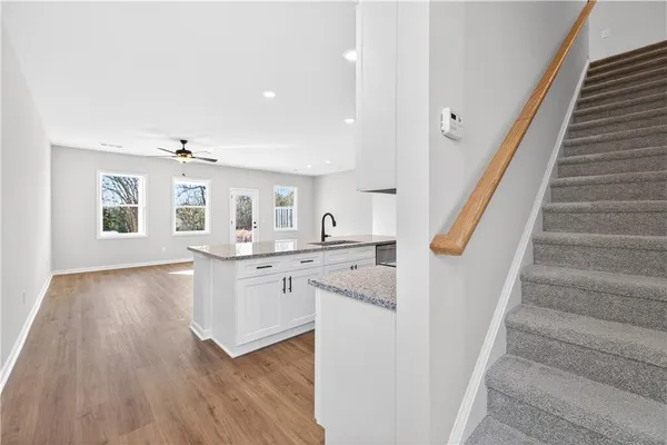 a view of a kitchen with sink and wooden floor
