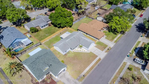 an aerial view of residential houses with outdoor space