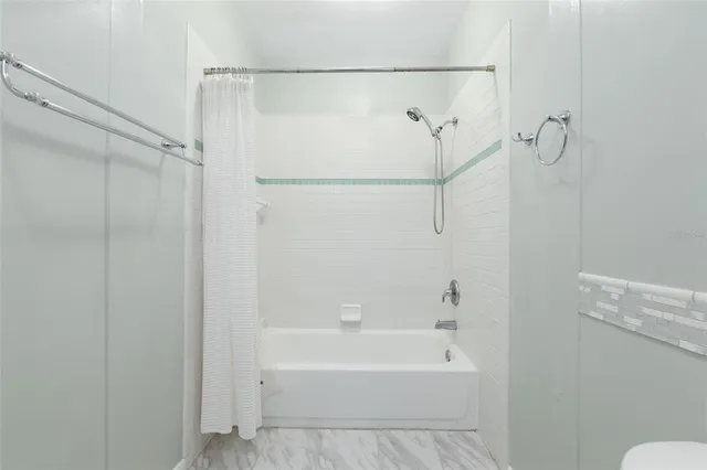 a bathroom with a granite countertop toilet sink and mirror