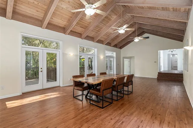 a dining room with furniture wooden floor and a chandelier