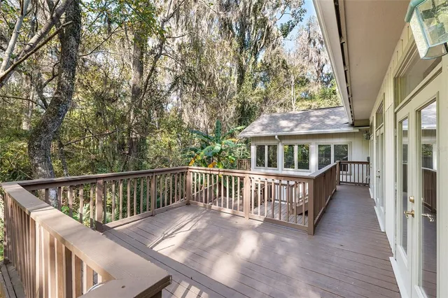 a view of balcony with wooden floor and fence