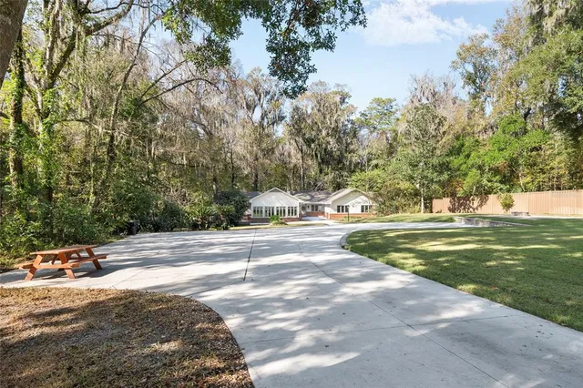 a front view of a house with a yard and potted plants