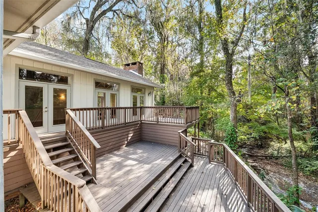a view of a balcony with wooden floor and fence