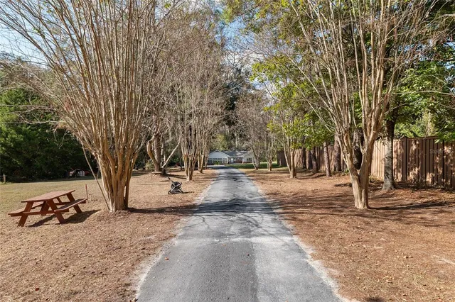 a backyard of a house with table and chairs