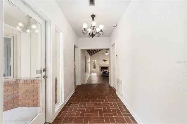 a view of a hallway with a chandelier