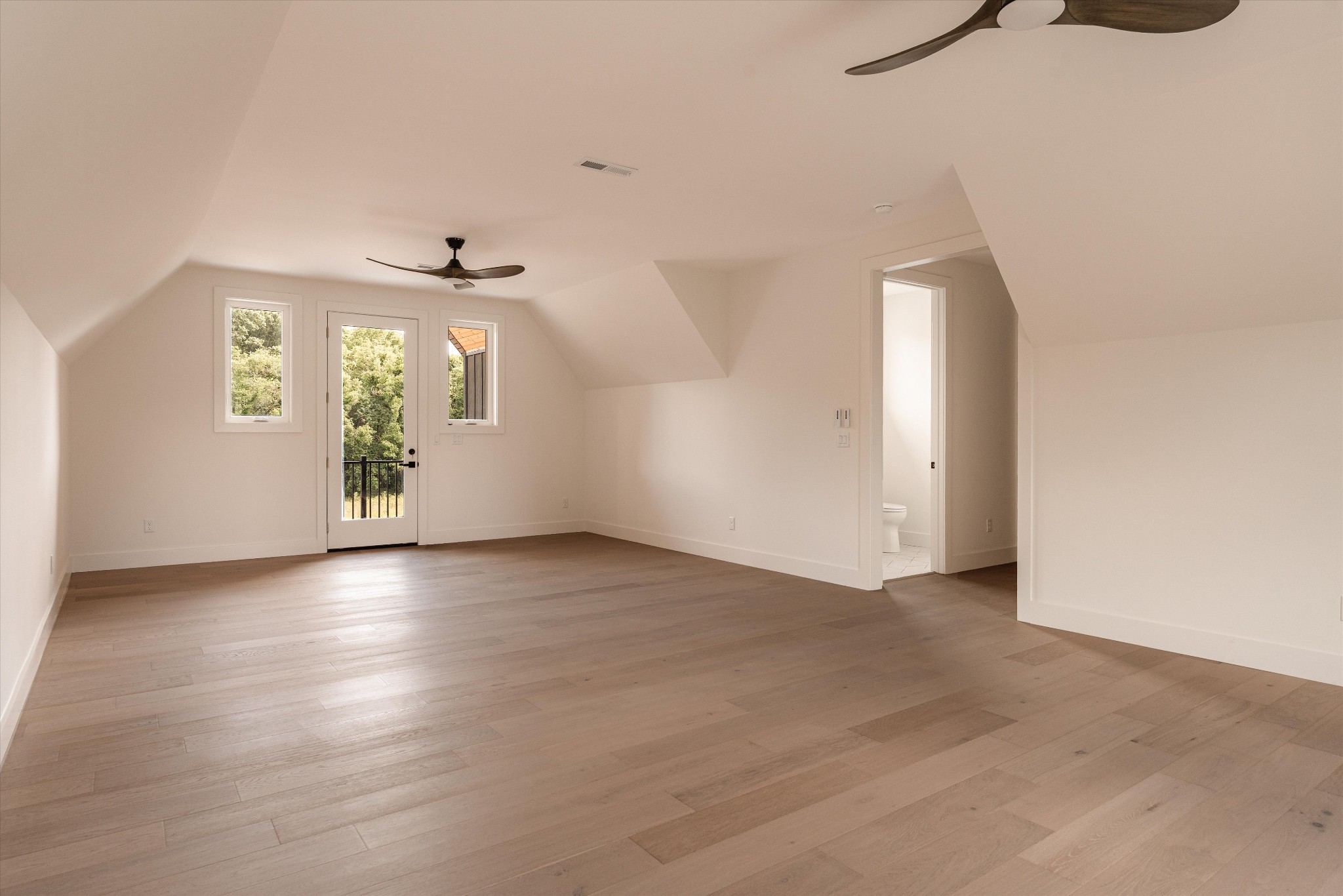 6801 Flat Creek Road College Grove, TN 37046 - Photo 57 of 66 an empty room with wooden floor and windows