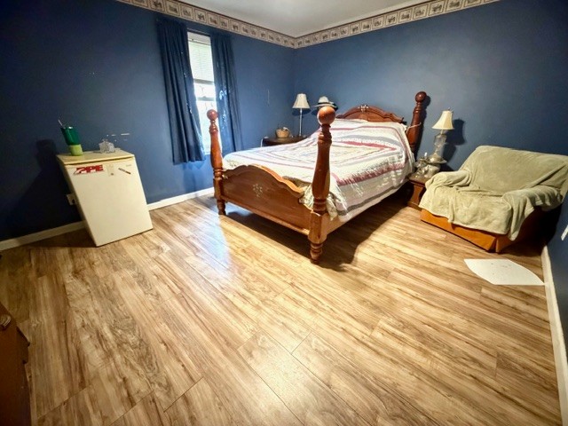 2575 Spur Road Decherd, TN 37324 - Photo 13 of 18 a bedroom with a bed and wooden floor