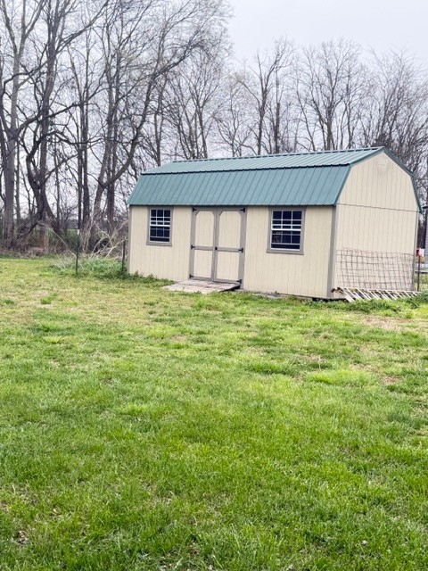 2575 Spur Road Decherd, TN 37324 - Photo 17 of 18 a view of a house with a yard and tree