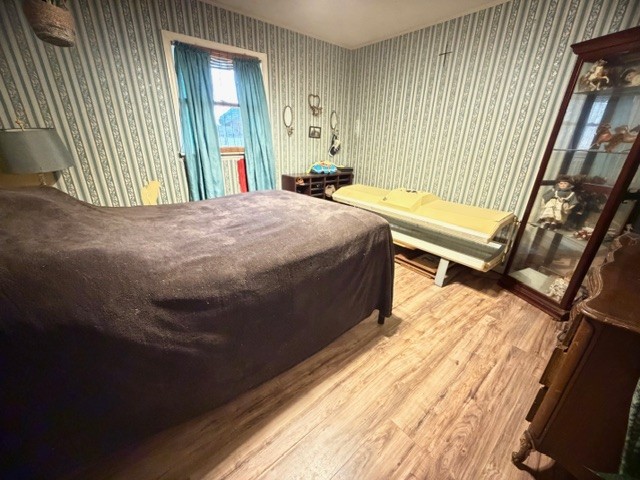 2575 Spur Road Decherd, TN 37324 - Photo 10 of 18 a bedroom with a bed and wooden floor