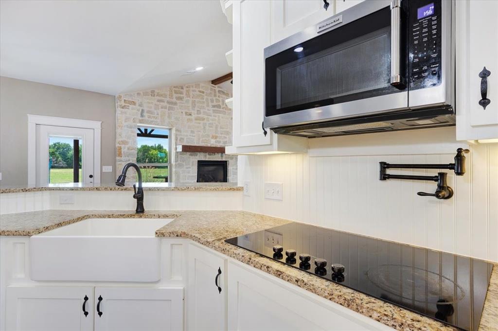516 Springtown Road Van Alstyne, TX 75495 - Photo 14 of 40 a kitchen with a stove and a microwave