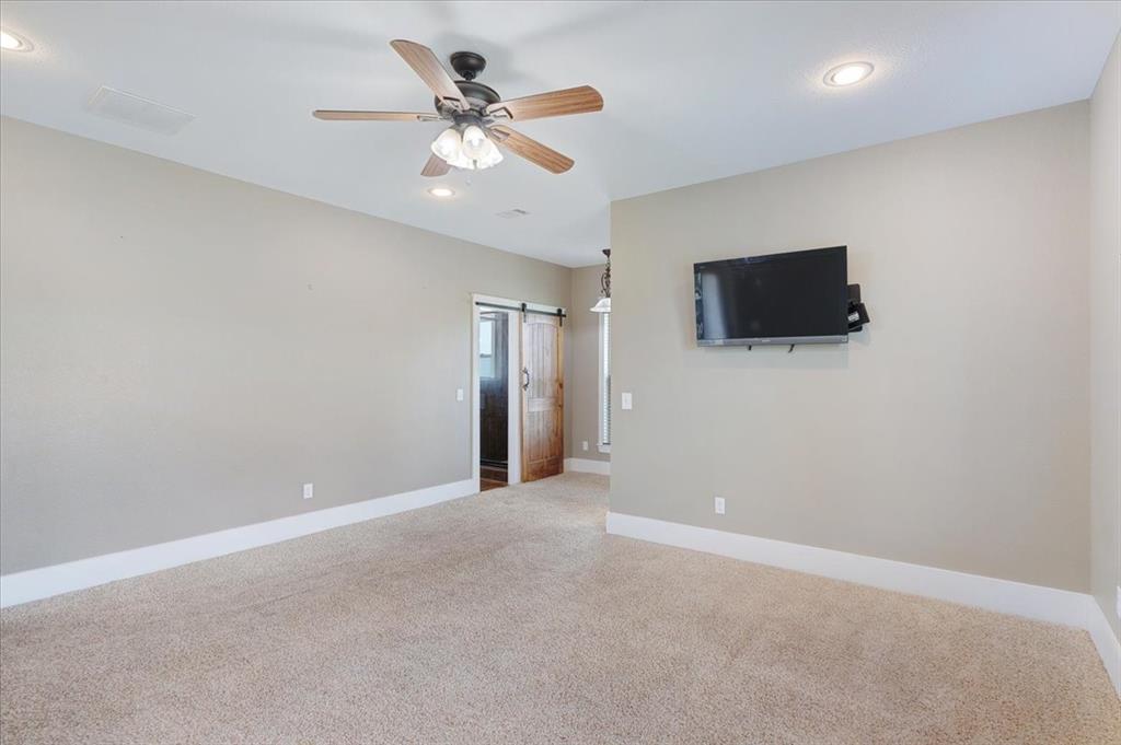 516 Springtown Road Van Alstyne, TX 75495 - Photo 19 of 40 en empty room with ceiling fan and window