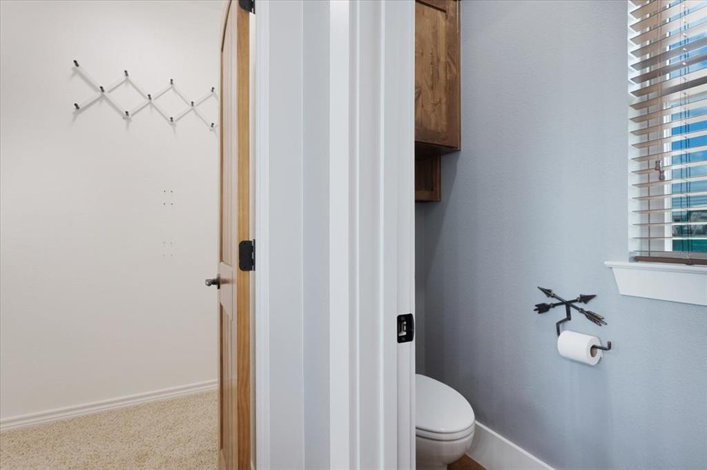 516 Springtown Road Van Alstyne, TX 75495 - Photo 23 of 40 a bathroom with a granite countertop toilet and a shower