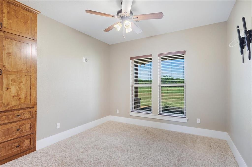 516 Springtown Road Van Alstyne, TX 75495 - Photo 26 of 40 an empty room with windows and ceiling fan
