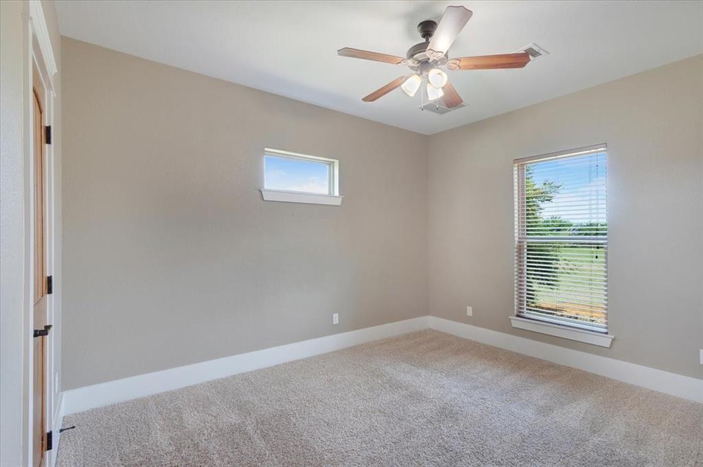 516 Springtown Road Van Alstyne, TX 75495 - Photo 28 of 40 an empty room with windows and fan