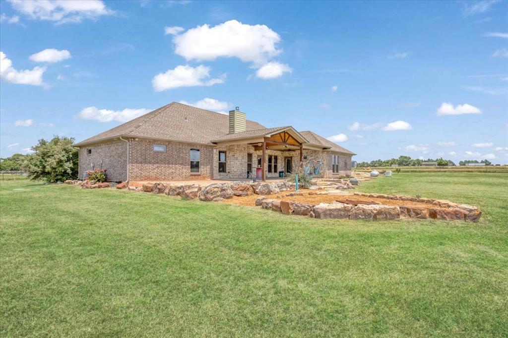 516 Springtown Road Van Alstyne, TX 75495 - Photo 32 of 40 a view of a house with a big yard and large trees