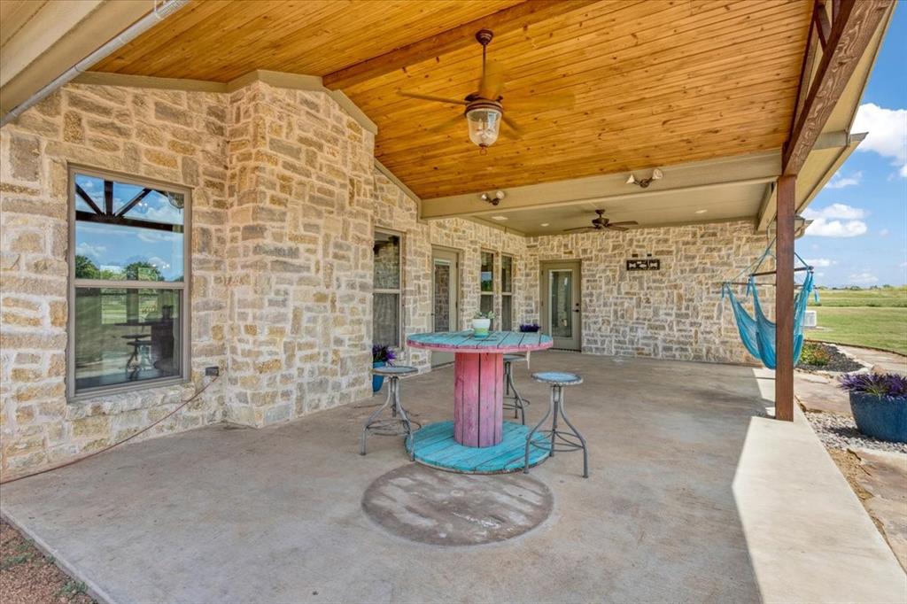 516 Springtown Road Van Alstyne, TX 75495 - Photo 33 of 40 a view of a patio with table and chairs and potted plants