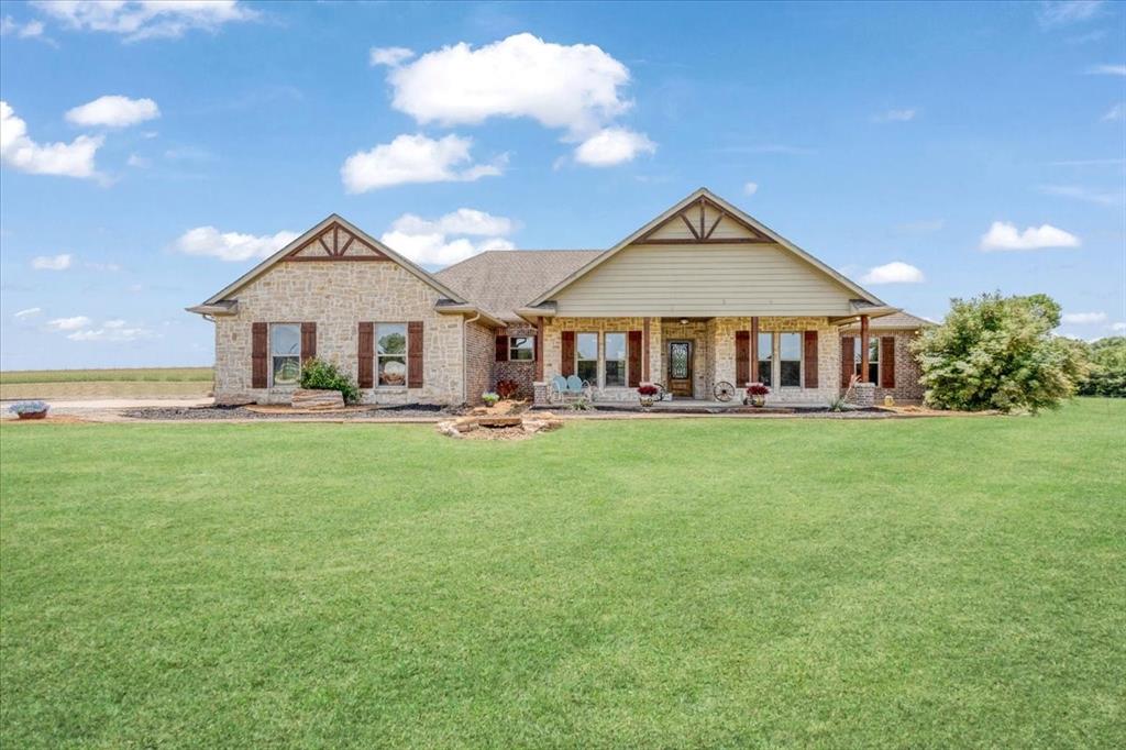 516 Springtown Road Van Alstyne, TX 75495 - Photo 4 of 40 a front view of a house with a yard and trees