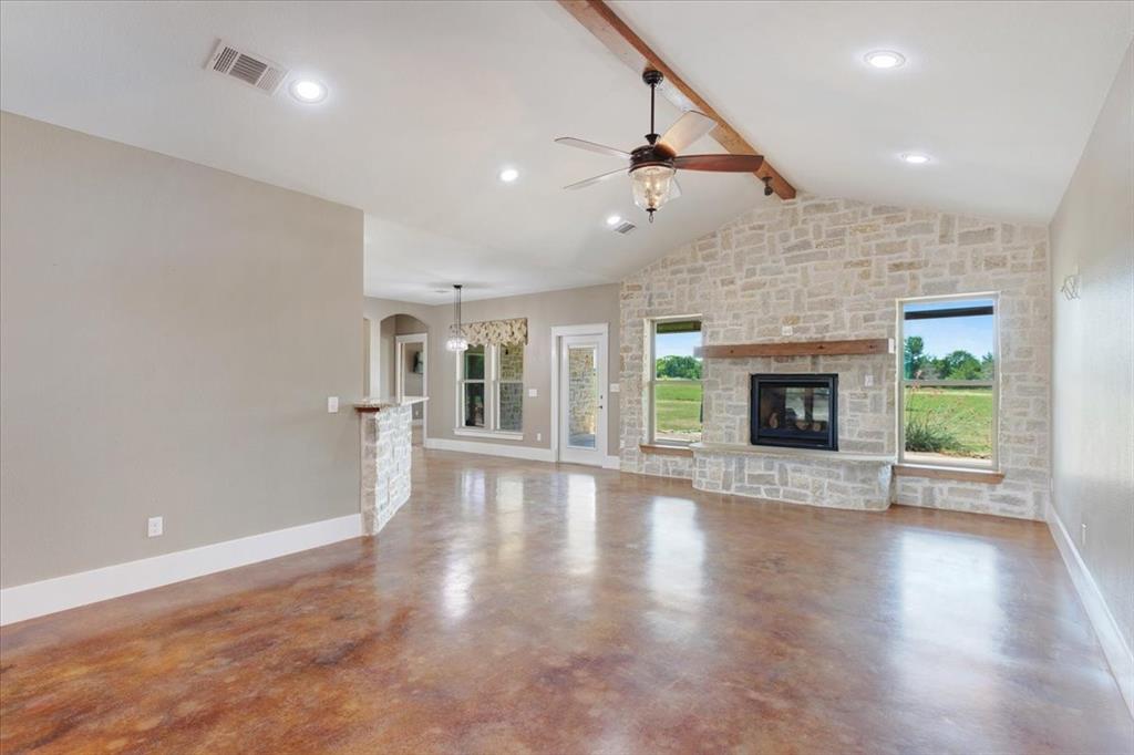516 Springtown Road Van Alstyne, TX 75495 - Photo 8 of 40 an empty room with wooden floor fireplace and windows