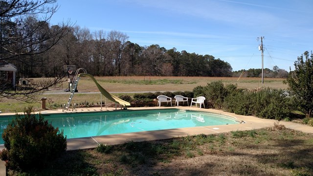 7808 Whittle Road Macon, GA 31220 - Photo 17 of 20 a view of a lake with a yard and potted plants