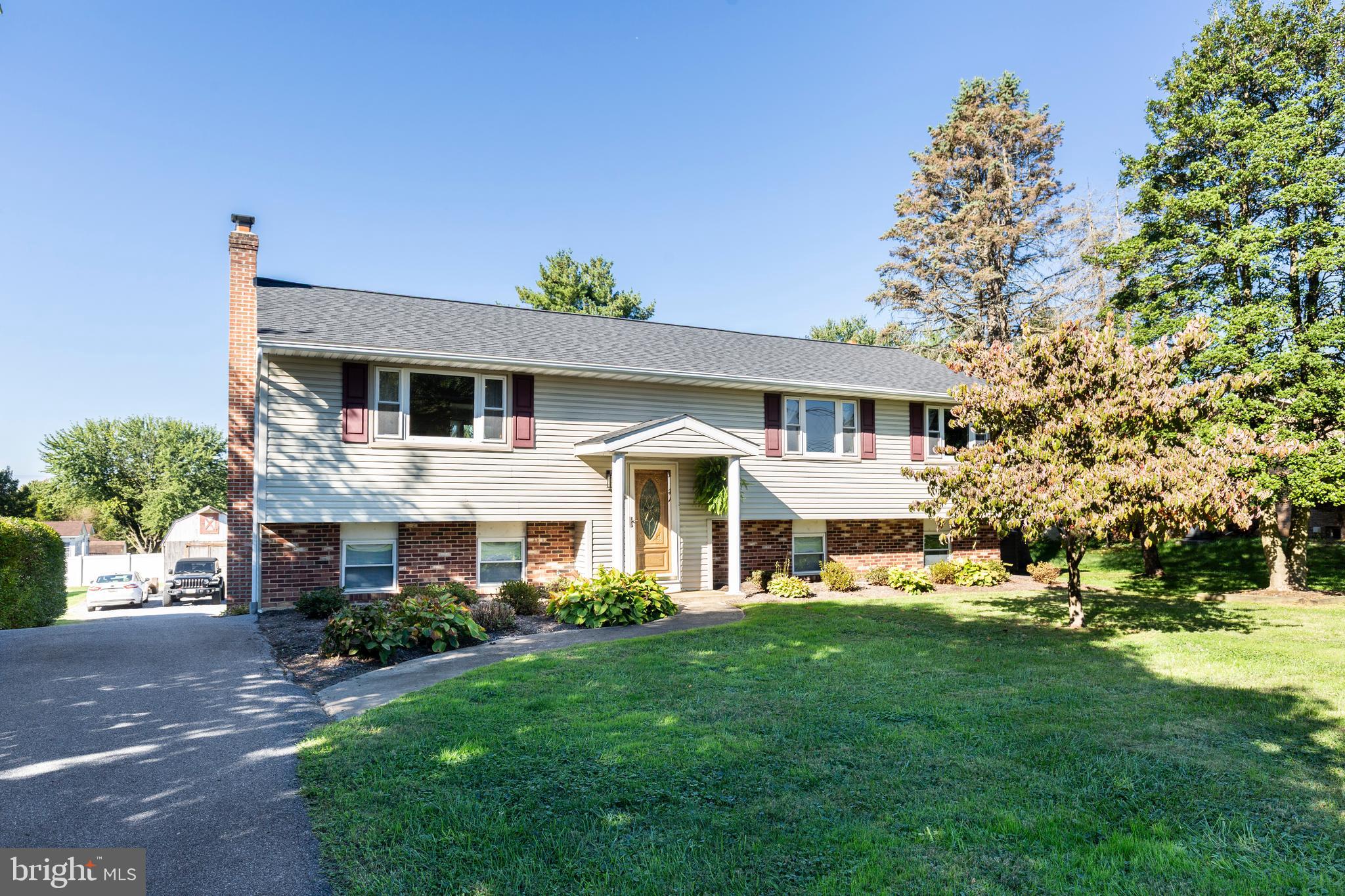 2108 Hanover Pike Hampstead, MD 21074 - Photo 1 of 51 a front view of a house with a garden