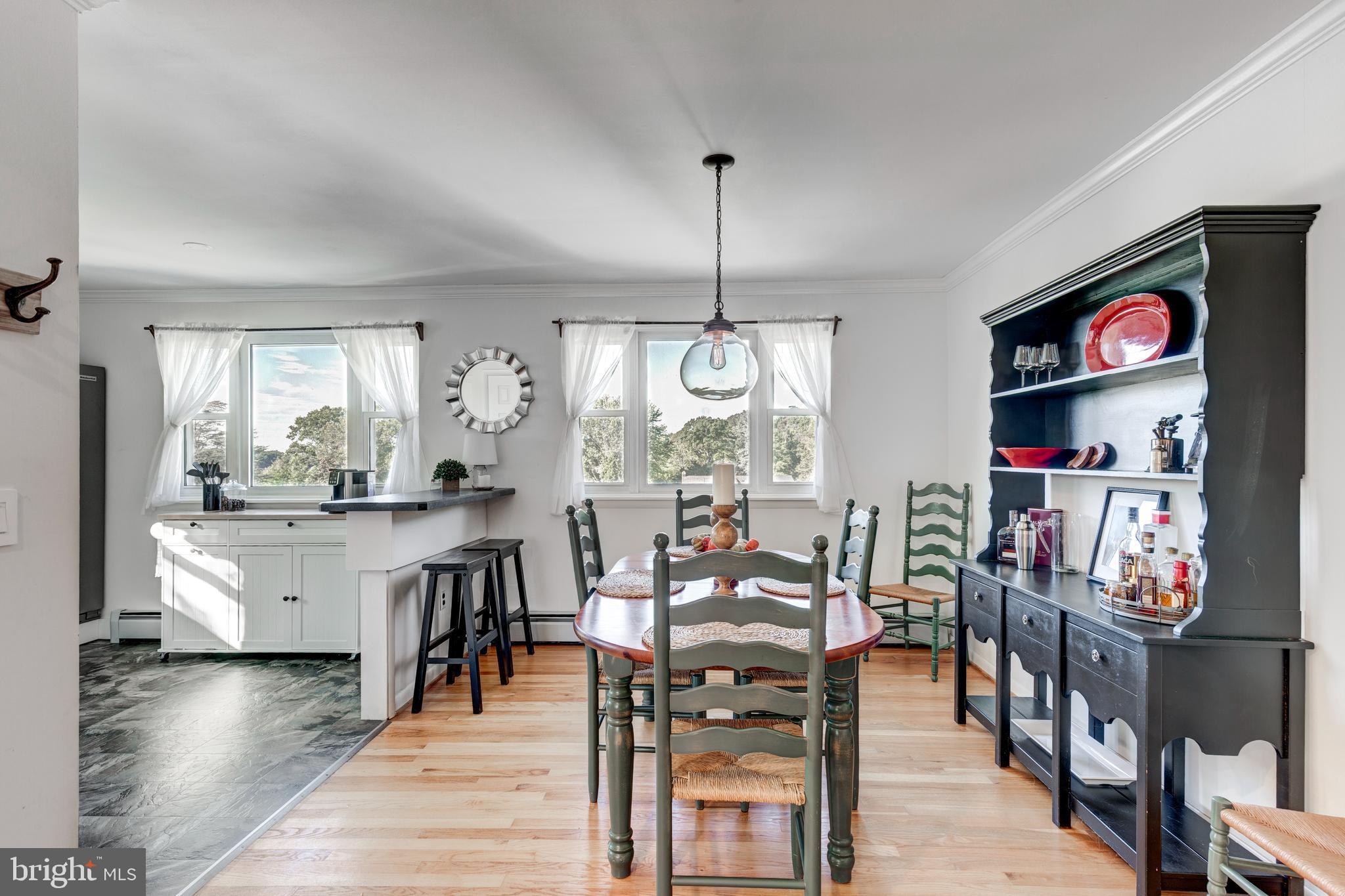 2108 Hanover Pike Hampstead, MD 21074 - Photo 14 of 51 a open dining room with stainless steel appliances furniture large window and wooden floor