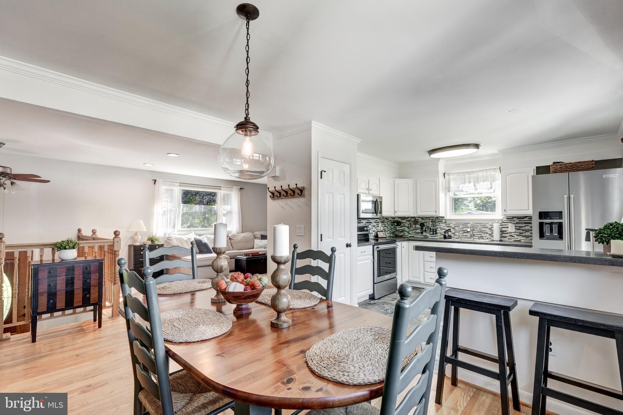2108 Hanover Pike Hampstead, MD 21074 - Photo 16 of 51 a dining room with furniture a chandelier and kitchen view
