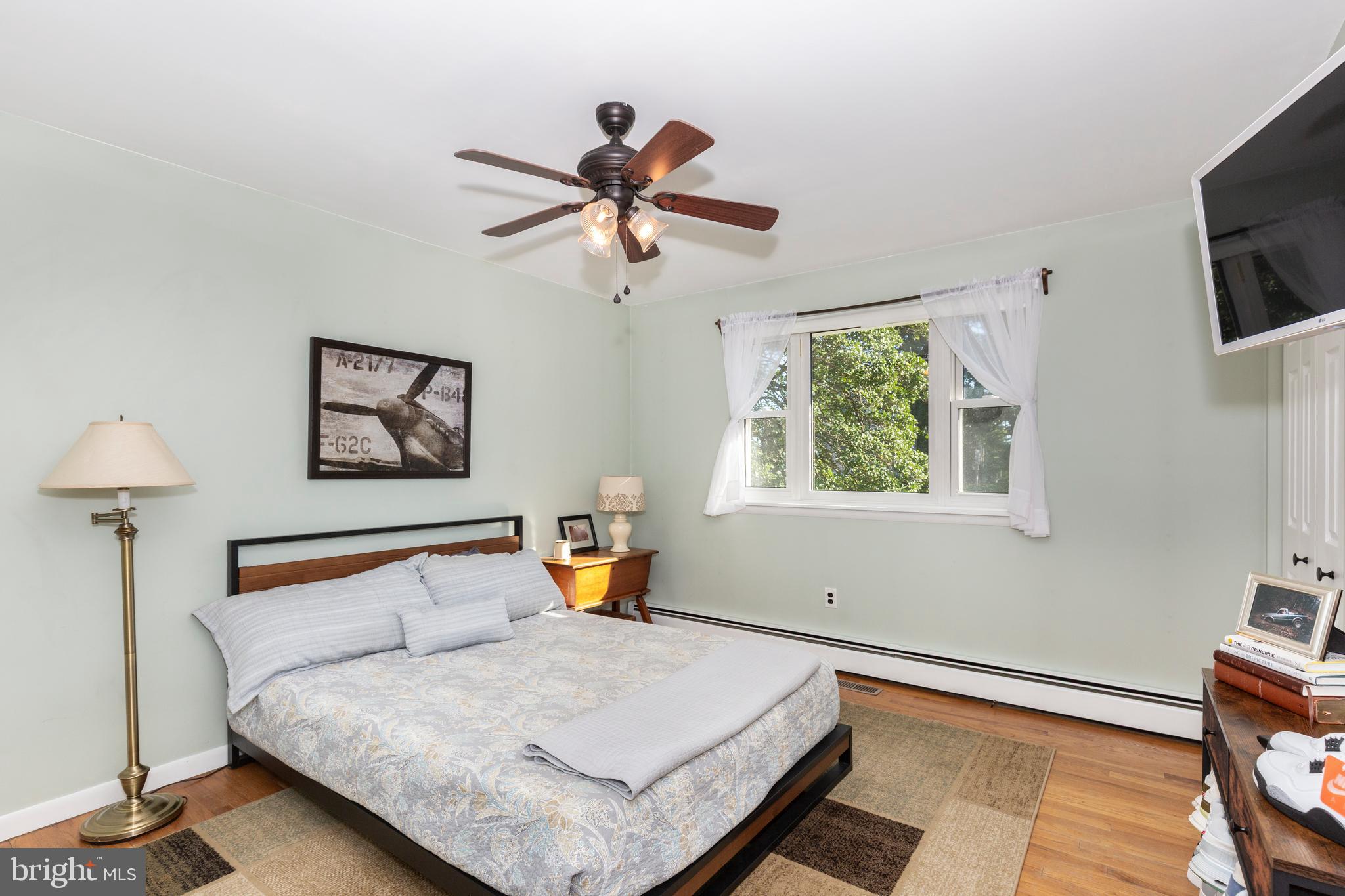 2108 Hanover Pike Hampstead, MD 21074 - Photo 25 of 51 a bedroom with a bed and a flat screen tv
