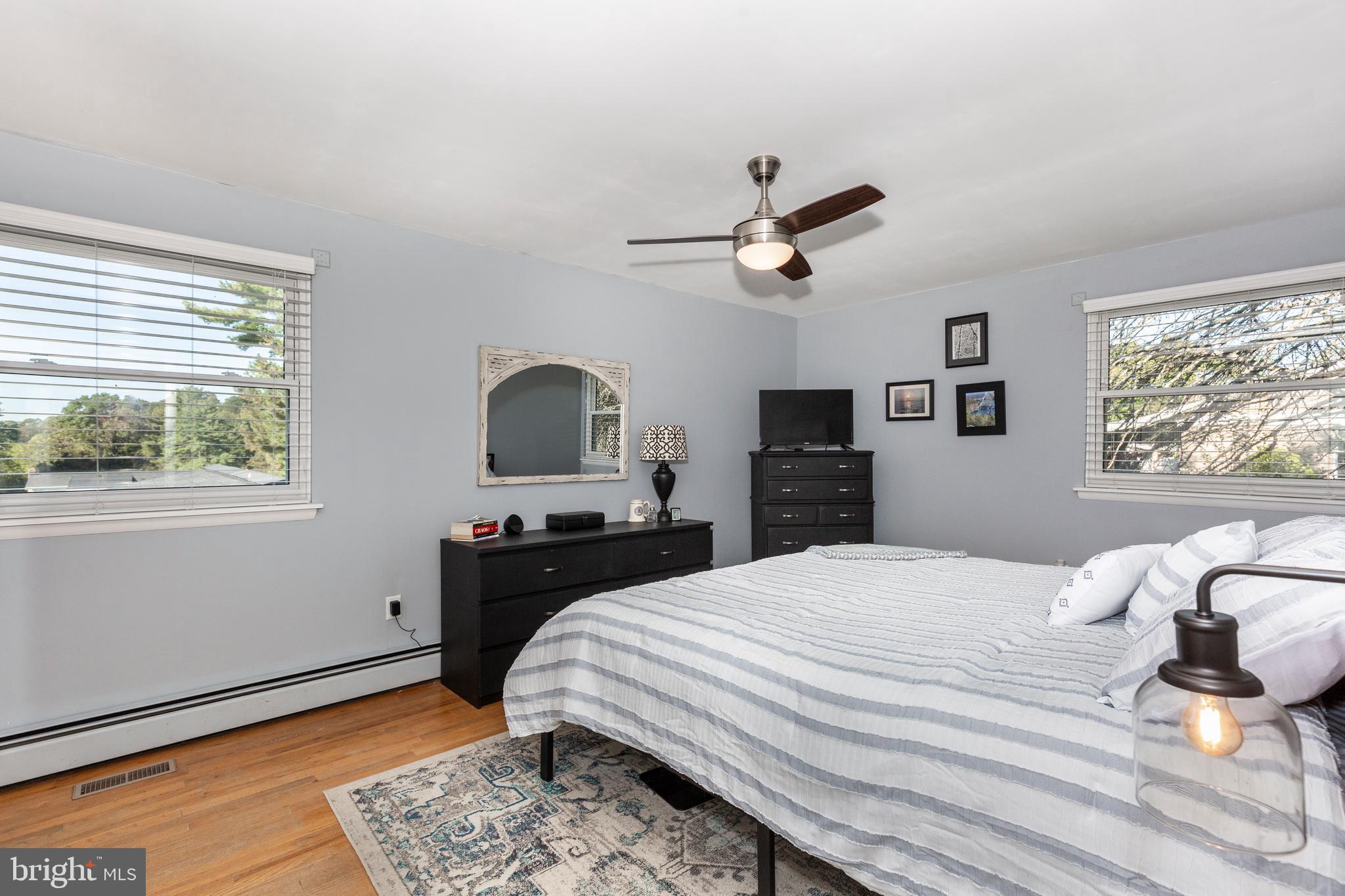 2108 Hanover Pike Hampstead, MD 21074 - Photo 27 of 51 a bedroom with a bed a window and wooden floor