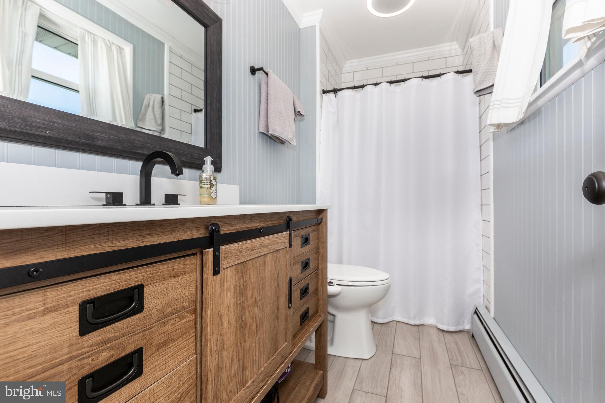 2108 Hanover Pike Hampstead, MD 21074 - Photo 30 of 51 a bathroom with a sink a toilet a mirror and shower