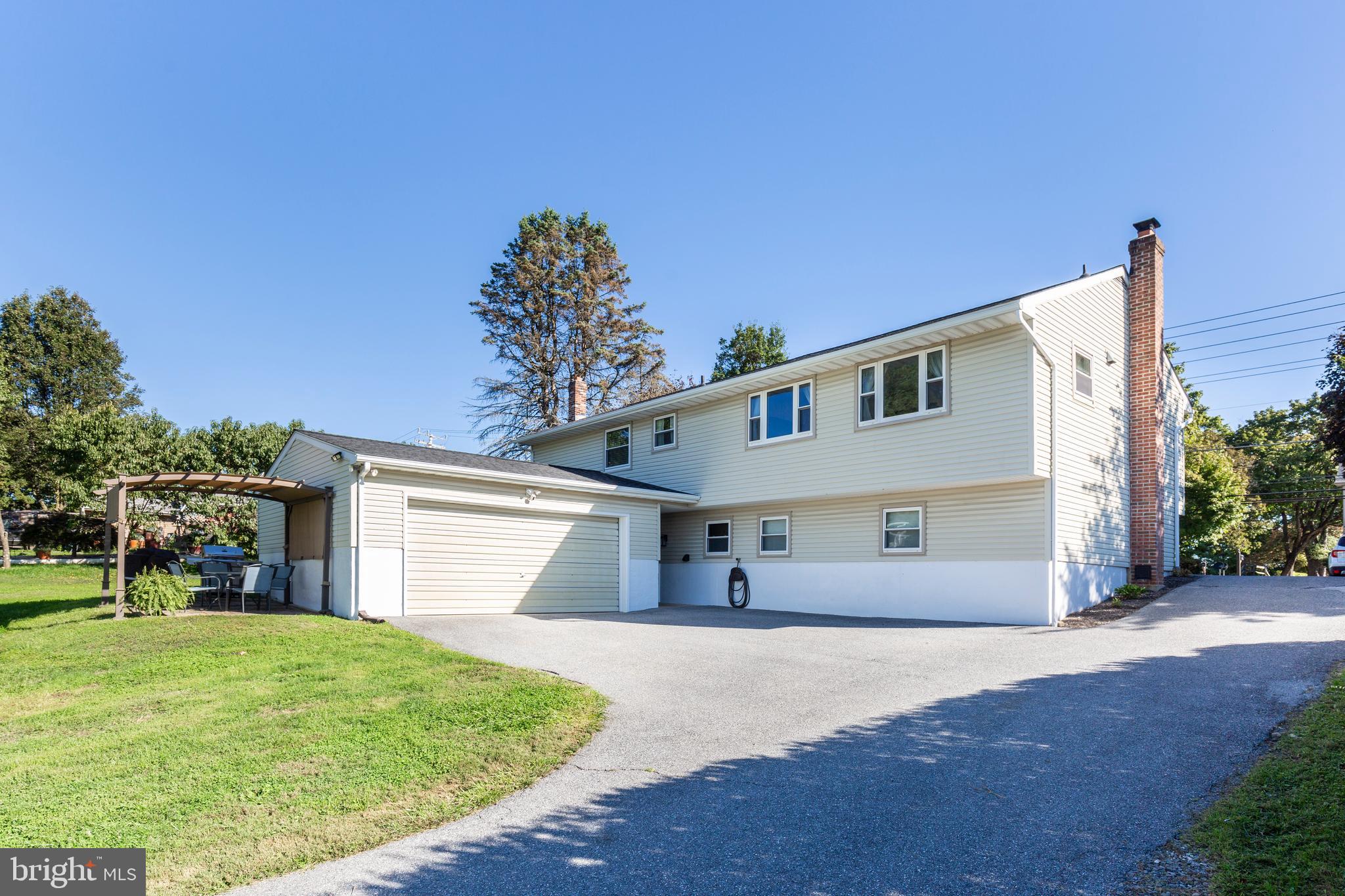 2108 Hanover Pike Hampstead, MD 21074 - Photo 47 of 51 a view of a white house with a yard and plants