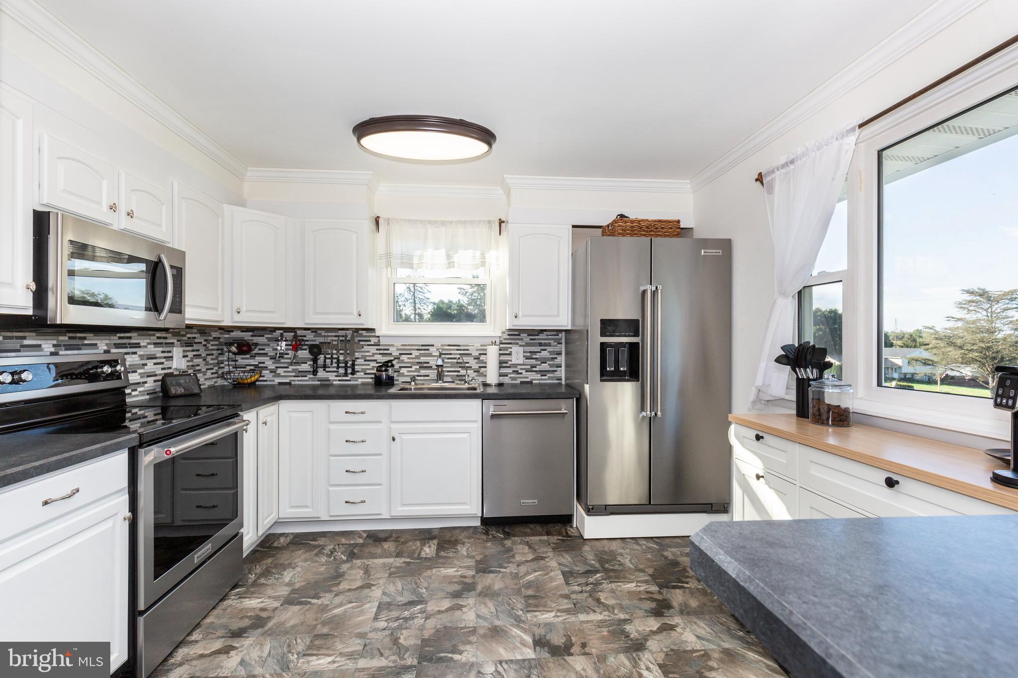 2108 Hanover Pike Hampstead, MD 21074 - Photo 9 of 51 a kitchen with stainless steel appliances granite countertop a refrigerator sink and stove