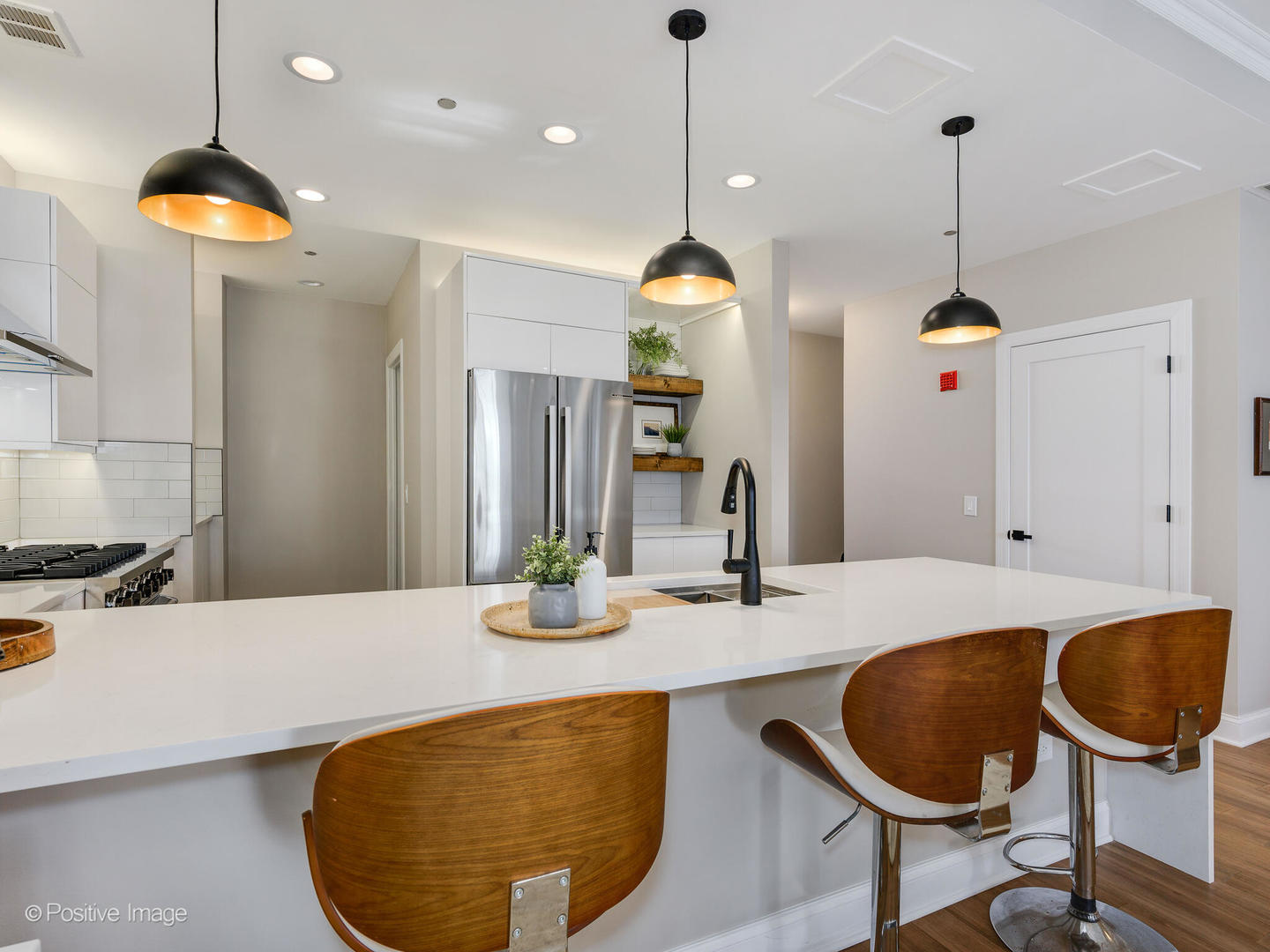 333 North Canal Street, Unit 2003 Chicago, IL 60606 - Photo 18 of 31 a kitchen with kitchen island a dining table and chairs