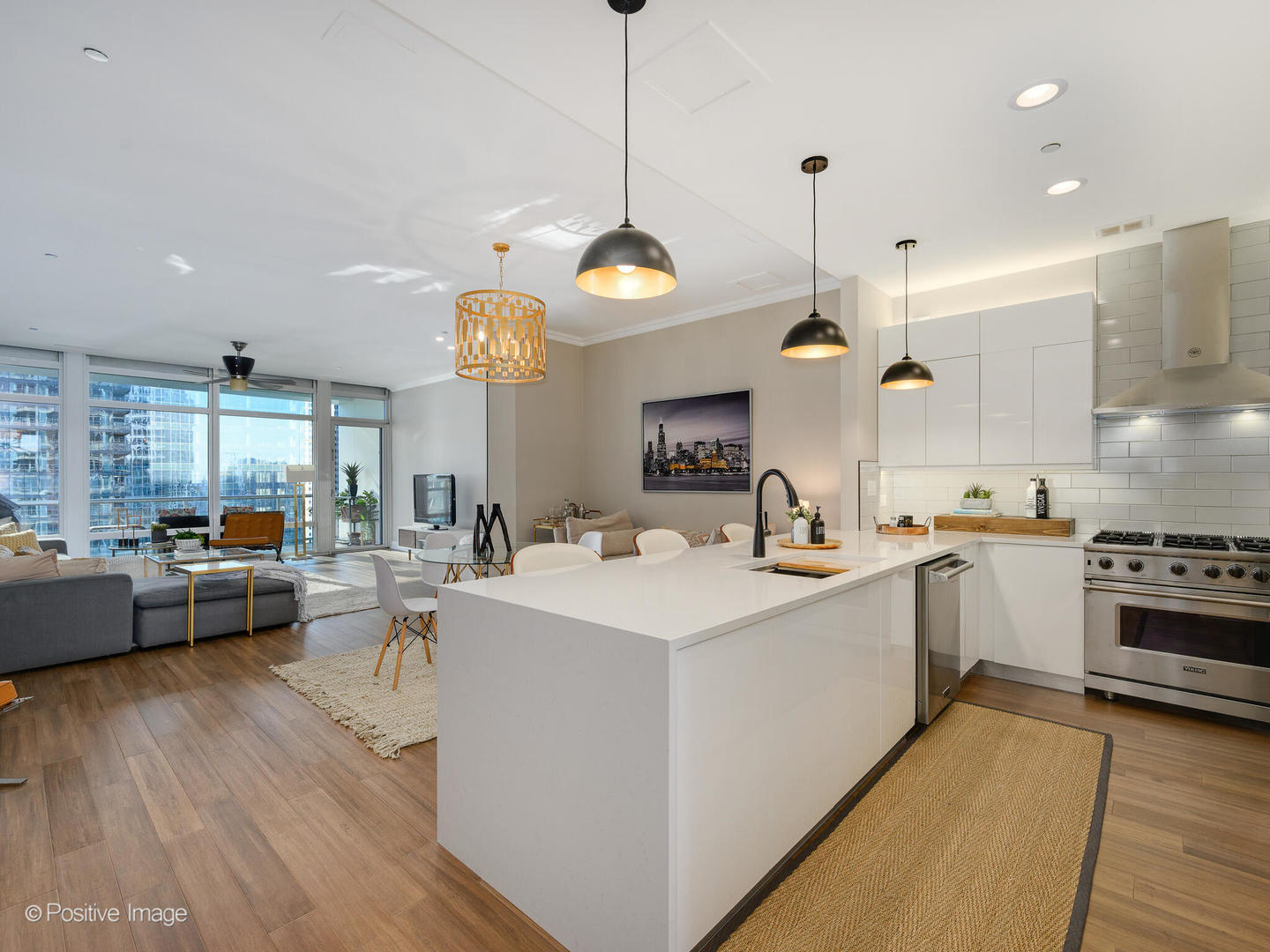 333 North Canal Street, Unit 2003 Chicago, IL 60606 - Photo 6 of 31 a large kitchen with kitchen island a stove a sink a center island and couches