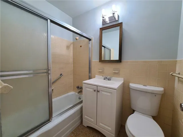 a bathroom with a toilet sink and shower