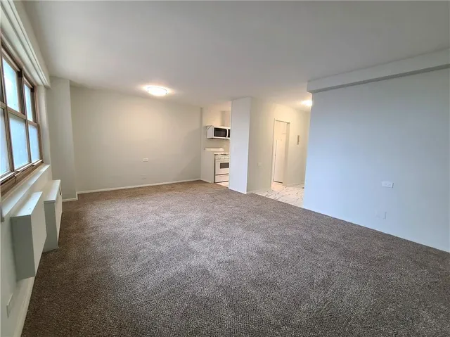 a view of a kitchen with a sink and a refrigerator