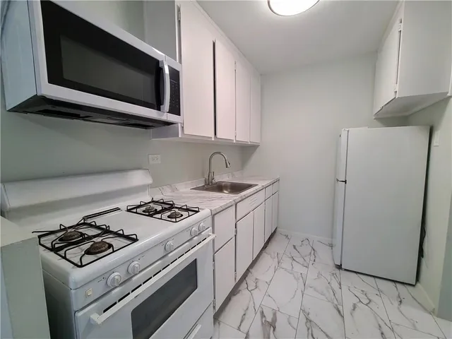 a kitchen with a stove and a microwave