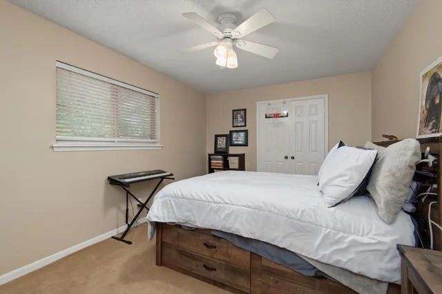 a bedroom with a bed and a dresser