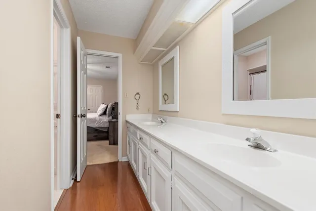 a spacious bathroom with a sink and a mirror