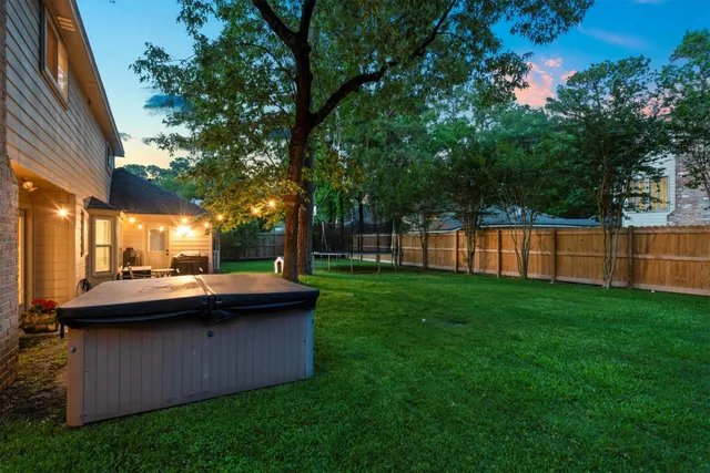 a view of a house with backyard and sitting area