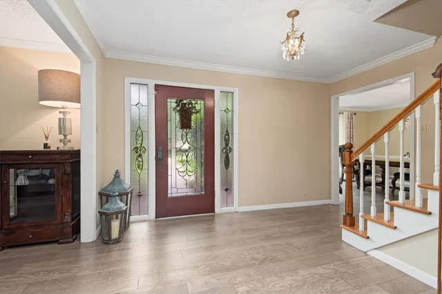 a view of an entryway with wooden floor and a livingroom view
