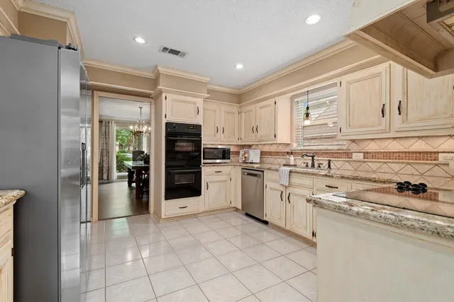 a kitchen with cabinets and stainless steel appliances