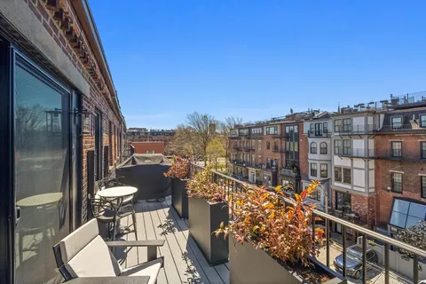 a view of a balcony with chairs