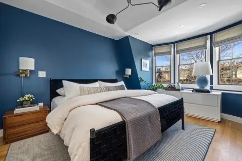 a spacious bedroom with a large bed and a large window