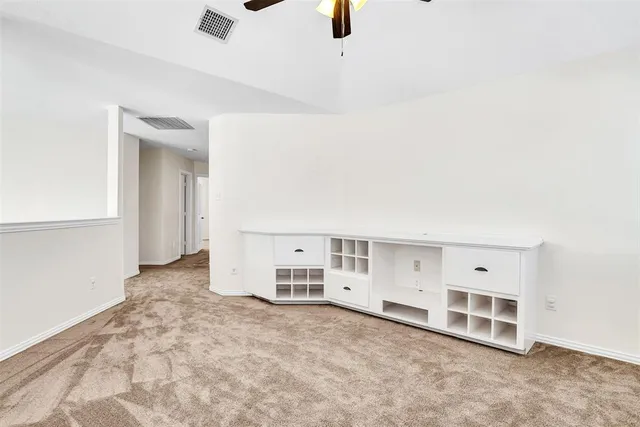 an empty room with a empty space and windows