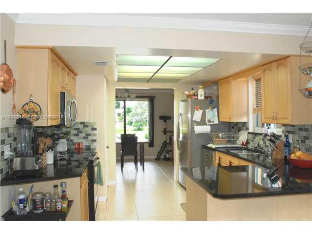 3339 West Park Road Hollywood, FL 33021 - Photo 15 of 15 a living room with stainless steel appliances kitchen island granite countertop furniture and a view of kitchen