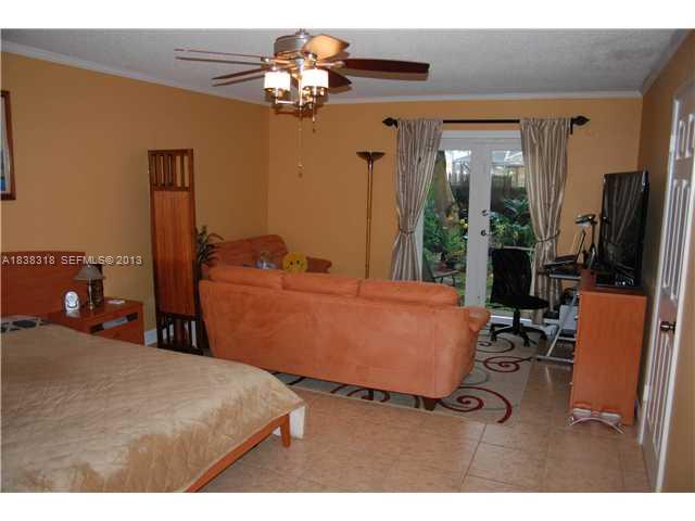 3339 West Park Road Hollywood, FL 33021 - Photo 7 of 15 a bed room with a bed mirror and a desk
