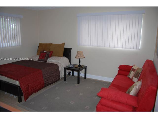 3339 West Park Road Hollywood, FL 33021 - Photo 9 of 15 a bedroom with a bed and window