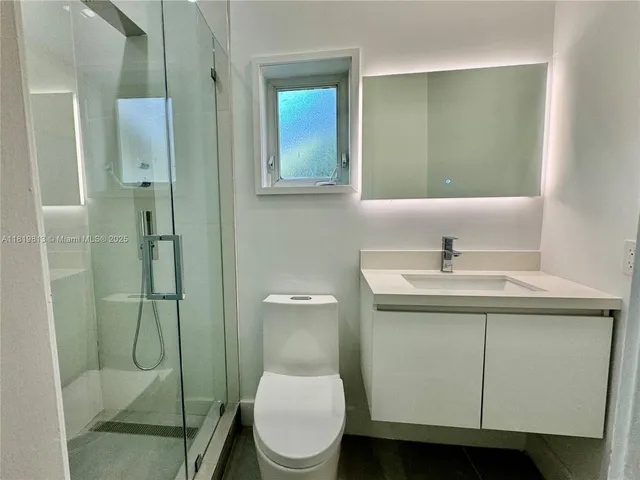 a bathroom with a toilet sink and shower