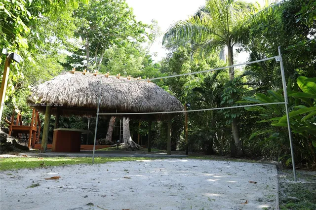 a backyard of a house with barbeque oven table and chairs